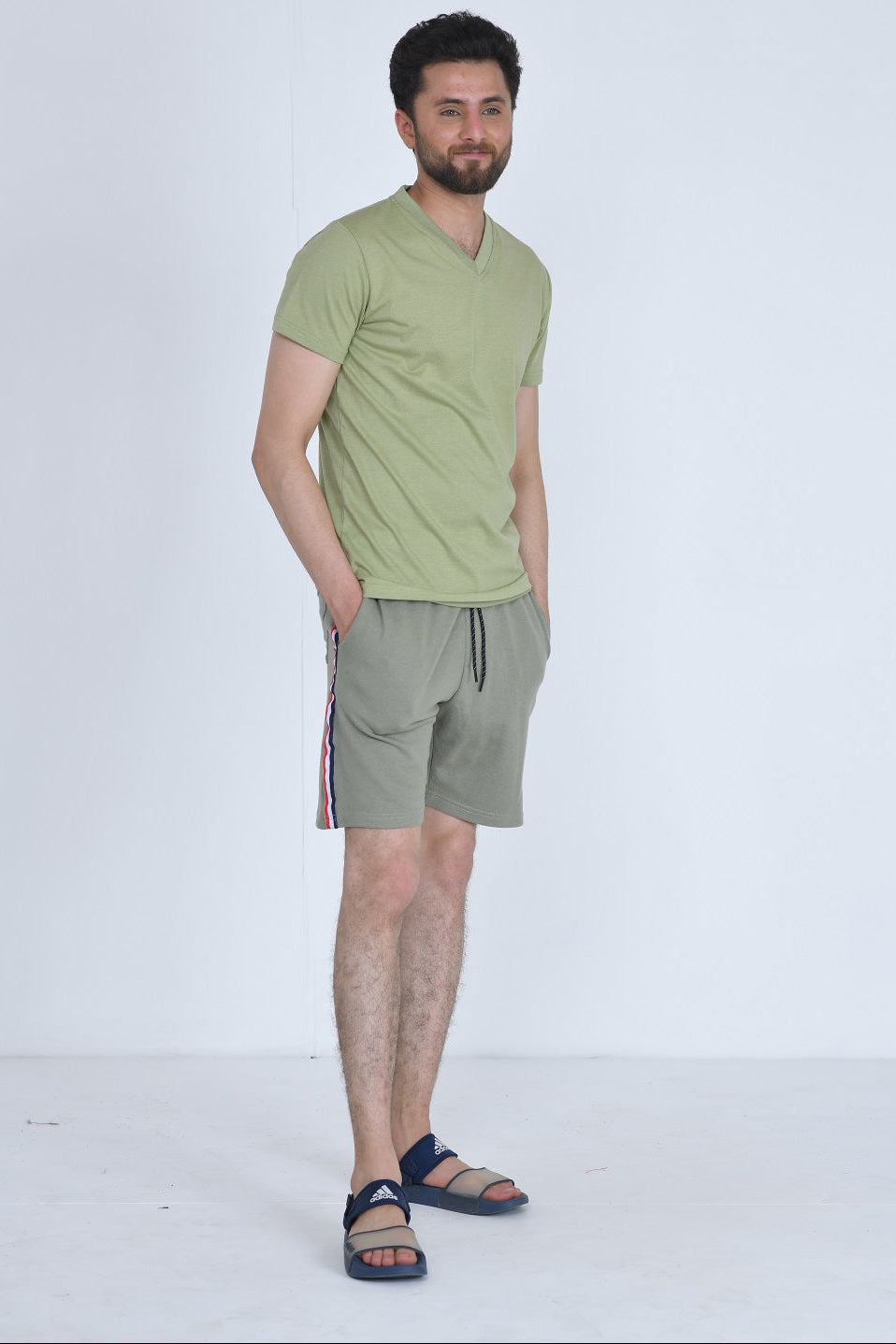 Men's olive gym shorts with strap detail - side view